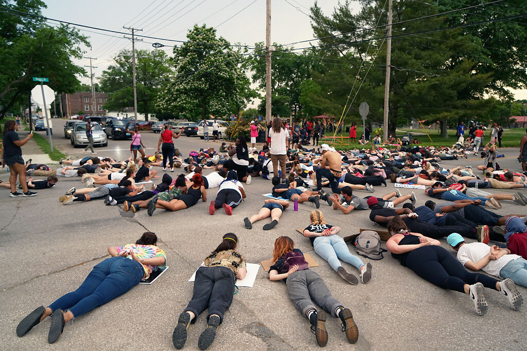Protesters lay on the ground Wednesday in front of Douglass Park